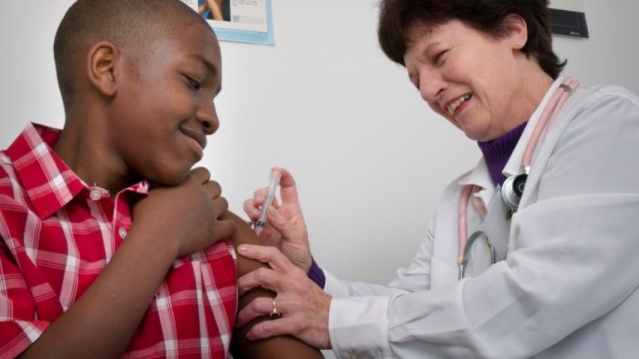 boy getting a vaccination from his pediatrician